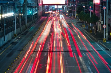 Night traffic lights with rows of cars  on the highway in the city