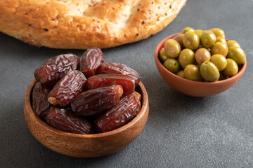 Ramadan pita, dates fruit and green olives.Islamic iftar table