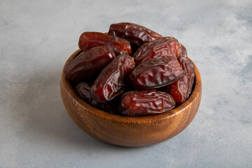 Date fruits in wooden bowl,closeup