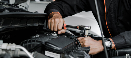 Mechanic fixing a car at home. Repair and service.
