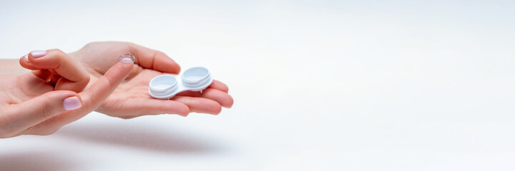 Contact Eye Lenses. Woman Hands Holding Contact Eye Lens. Woman Hands Holding White Eye lens Container. Beautiful Woman Fingers Holding Eye Lens Box. 
