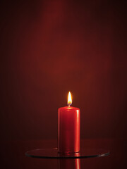 Red candle on a red background