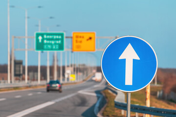 Mandatory direction sign on multiple lane highway in Serbia