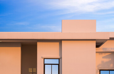 Golden sunlight on Geometric pattern surface of White Modern Office Building wall in Minimal style against blue sky in the morning, Exterior Architecture background