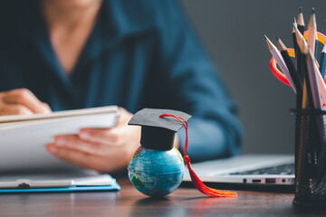 Graduation cap with Earth globe. Concept of global business study, abroad educational, Back to...