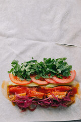 Shawarma preparation. Meat, vegetables and sauce on pita bread.