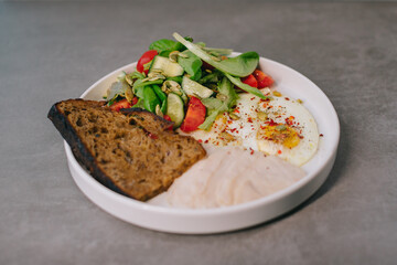 Food on an elegant white plate, lunch or dinner dish. Delicious food in a restaurant close-up..