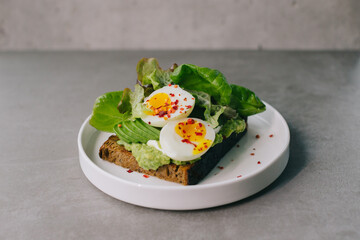 Delicious toast with avocado and boiled egg. Concept of delicious food.