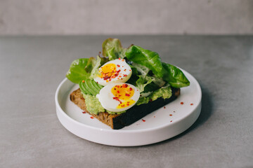 Delicious toast with avocado and boiled egg. Concept of delicious food.
