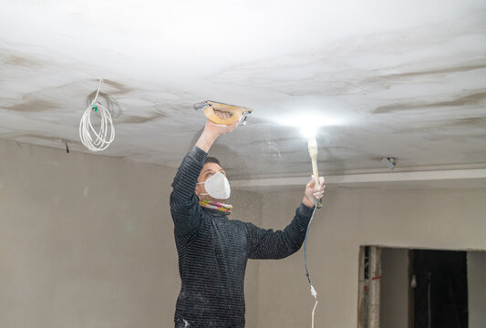 hand sanding of the plasterboard ceiling with a trowel
