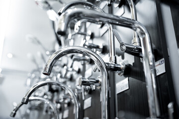 Obraz premium Rows of metal water taps at the showroom of a large store