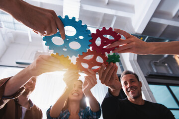 Business team connect pieces of gears. Teamwork, partnership and integration concept