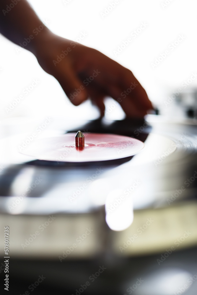 Wall mural dj mixing vinyl records on hip hop party. close up photo of disc jockey playing music on bright conc