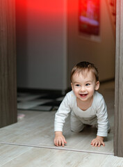 Joyful happy son having fun on the floor. Playful little child on the floor.