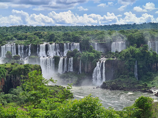 Fototapeta premium Forest surrounding a cascade of waterfalls in foz do iguacu, one of the 7 natural wonders f the world.