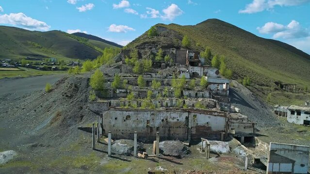 Aerial view of an abandoned factory in natural landscape. Ruined mountain-concentrating combine.