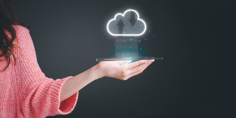 Woman's hand holding digital tablet with virtual cloud computing to transfer data information and upload download application. database, backup, storage, server, technology transformation concept.