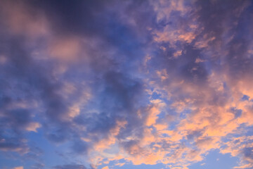 Bottom view on clouds at sunset. Colorful sky and cloudscape. For background, wallpaper, digital artwork use and etc..