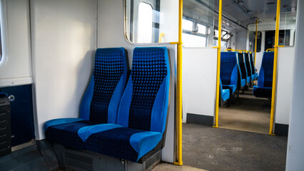 Empty train seats. Blue Colored Train Seats and Warning Signs