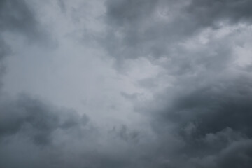 Cloudy sky with gray clouds, dark stormy clouds. Dramatic thunder clouds grey overcast. For background, wallpaper, digital artwork use and etc..