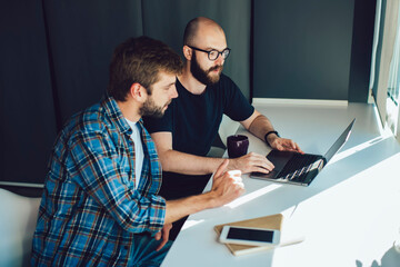 Concentrated coworkers in office working on project using netbook