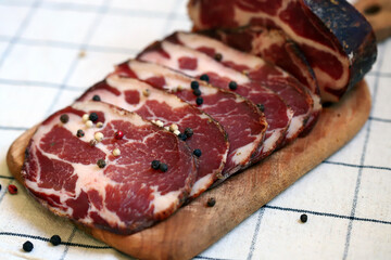 Capocollo. Italian ham slices on the board.