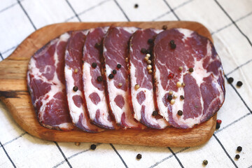 Capocollo. Italian ham slices on the board.