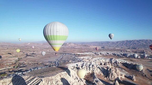 Aerial view of hot air balloons flying above spectacular volcanic landscape of Cappadocia. Goreme national park. UNESCO World Heritage site. Nevsehir province, Turkiye