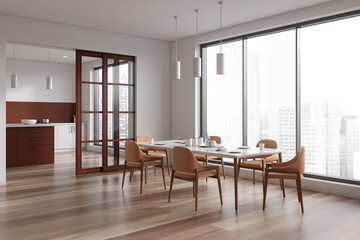 White kitchen interior with eating and cooking room, panoramic window