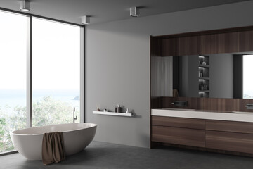 Fototapeta na wymiar Grey bathroom interior with double sink and tub near panoramic window. Mockup