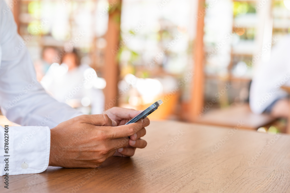 Poster man hands with smartphone typing on blurred background