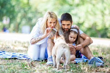 A happy family enjoying nature and having fun with their daughter