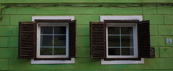an old wooden window on an old wall.