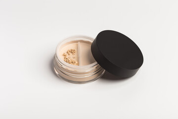 Mineral makeup powder twist seal sifter isolated on white background. Light beige foundation powder. Skin tone face cosmetic product sample