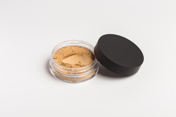 Mineral makeup powder isolated on white background. Light beige foundation powder. Skin tone face cosmetic product sample