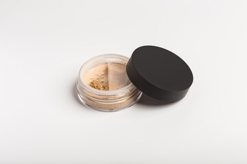 Mineral makeup powder twist seal sifter isolated on white background. Light beige foundation powder. Skin tone face cosmetic product sample