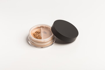 Bronzer or brown eye shadow mineral face powder twist seal sifter. Facial powder isolated on white background