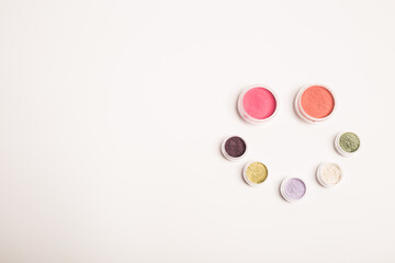 Many colorful natural mineral eyeshadows isolated on white background with copy space and empty space for text