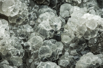 calcite clear crystal cluster. macro detail texture background. close-up raw rough unpolished semi-precious gemstone