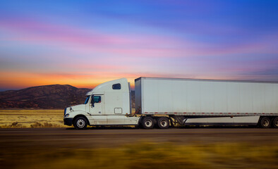 Semi Trucks on the Nevada Highway at twilight sky, USA. Trucking in Utah