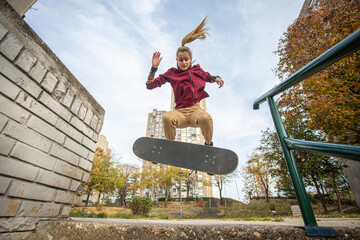 Female skater enjoys riding and jumping with her skate © Branimir