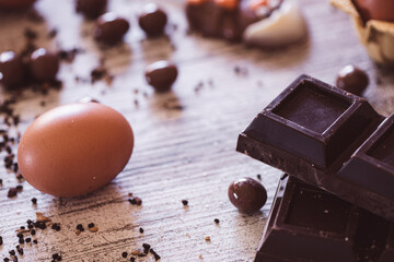 Chocolate easter chick with chocolate bar and eggs in the background