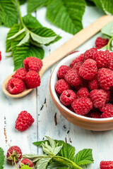 Jar of raspberry jam and fresh berries, vertical image. top view. place for text