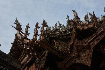 A temple with a red roof and a blue sky in the background.