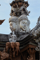 A temple with a red roof and a blue sky in the background.