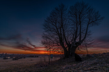 Winter sunset with color sky near Andelska Hora village with ruins and chapel