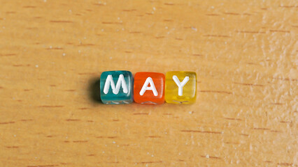"May" word in colorful cubes. concept of months of the year, time. fun concept of time for kids