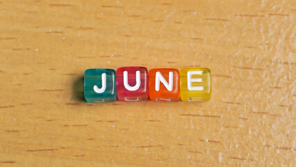 "June" word in colorful cubes. concept of months of the year, time. fun concept of time for kids