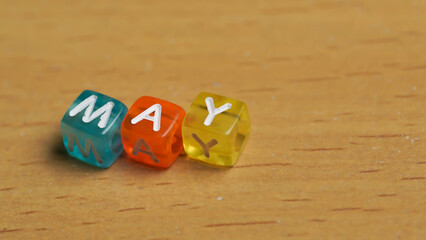 "May" word in colorful cubes. concept of months of the year, time. fun concept of time for kids