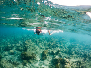 woman snorkeling in clear tropical sea